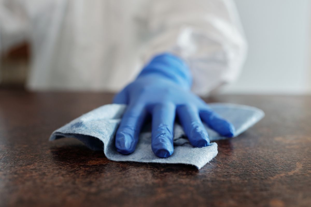 Dover, NJ Office Cleaning Services Gloved hand disinfecting a surface during medical office cleaning in Dover, NJ